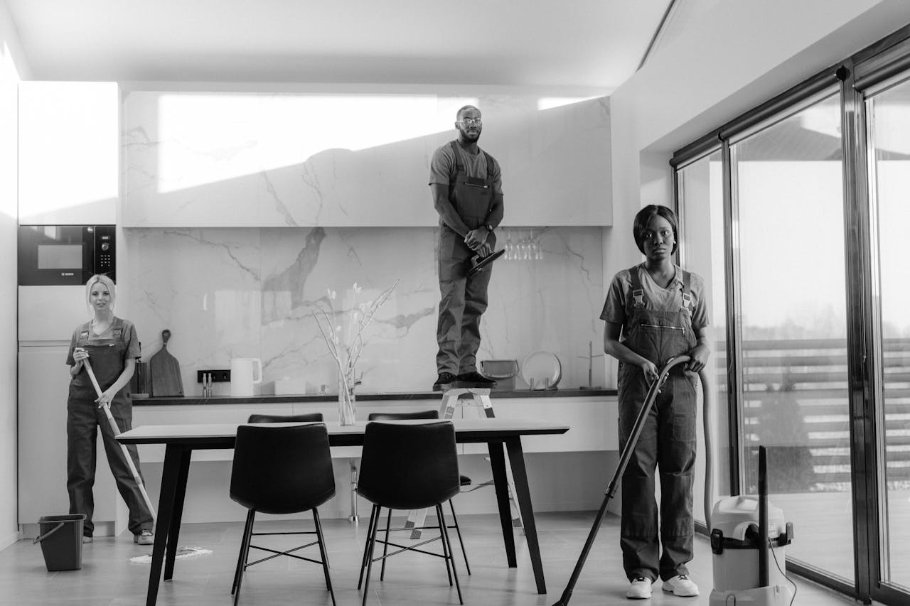 about-us-01 A team of professional cleaners working in a modern dining room setting, enhancing interior cleanliness.
